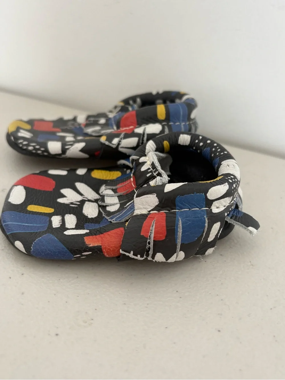 Freshly Picked Black Moccasins with Red, Blue & Yellow Abstract Print